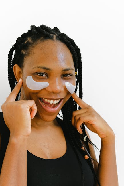Cheerful African American female with white eye patches on cheeks smiling and looking at camera