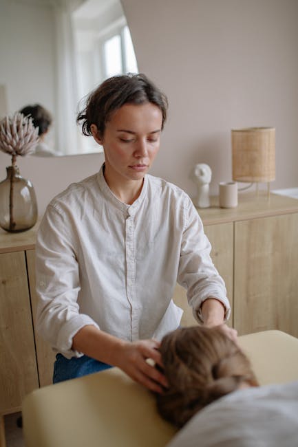 Woman receiving a soothing massage from a skilled therapist indoors.