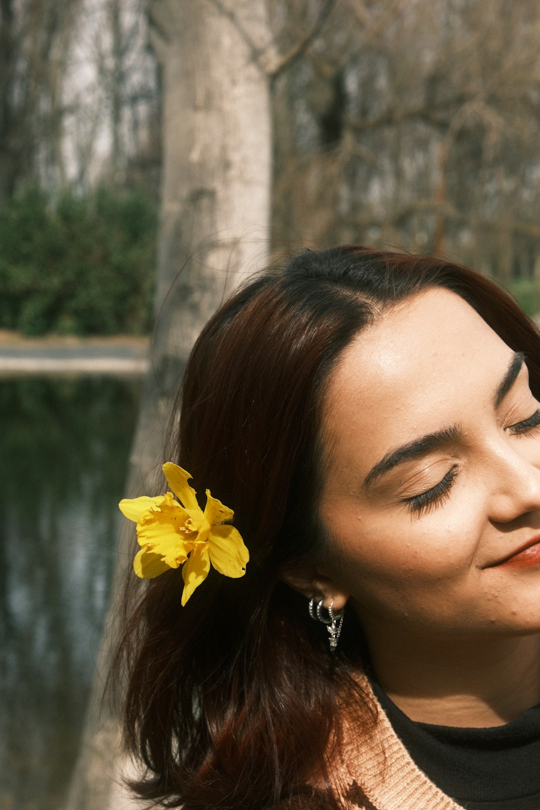 a woman with a yellow flower in her hair