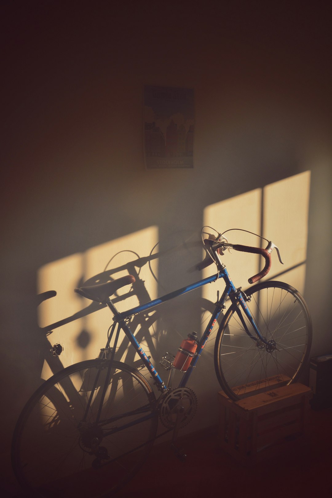 a bike parked in a room next to a window
