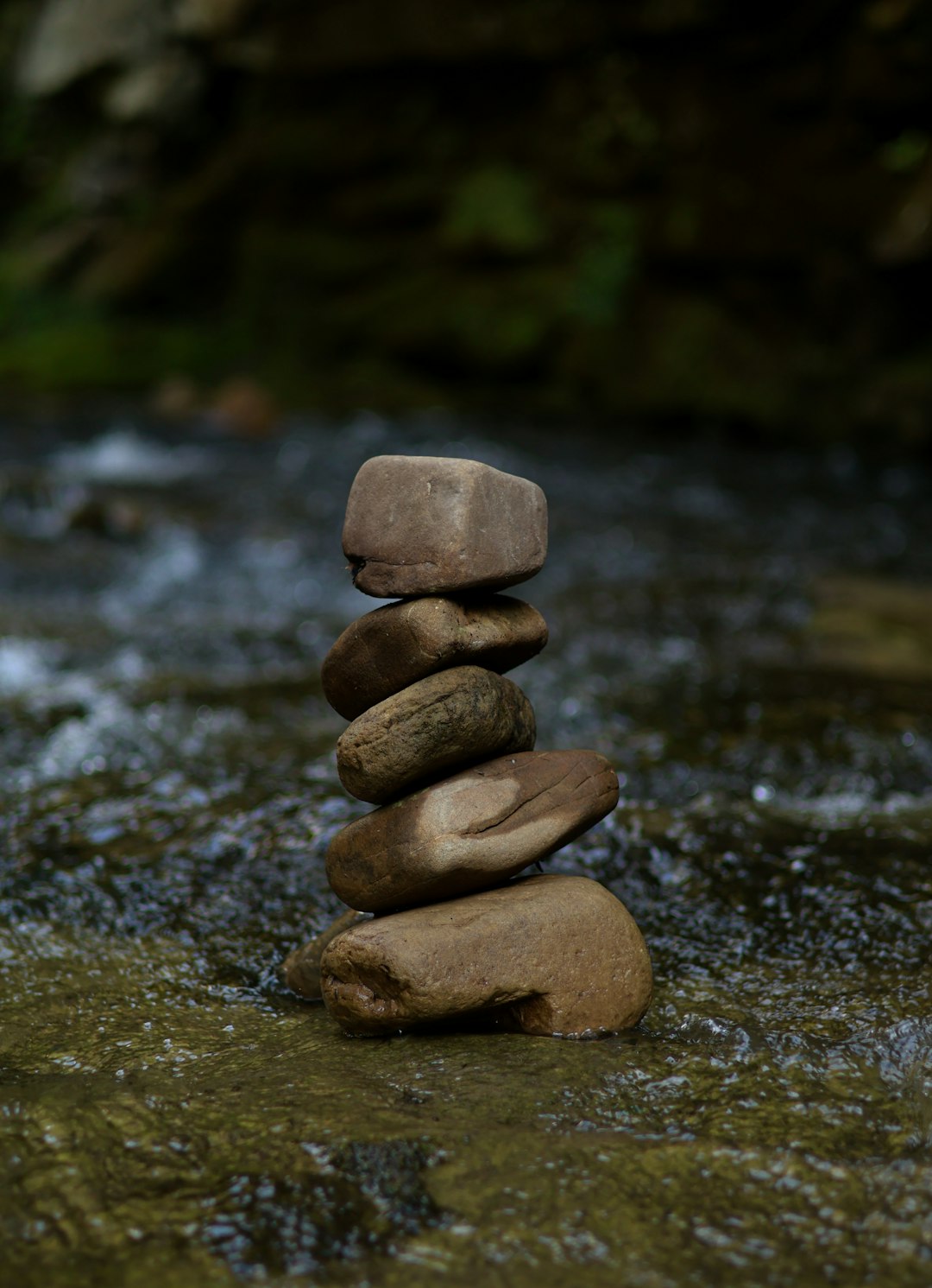 a stack of rocks sitting on top of a river