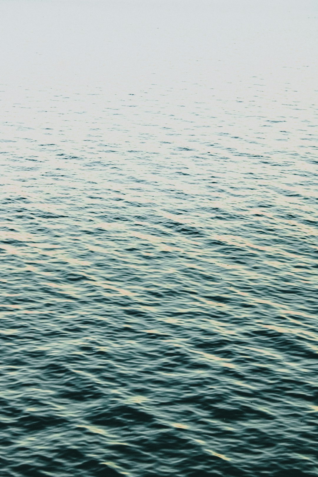 a man riding a surfboard on top of a body of water