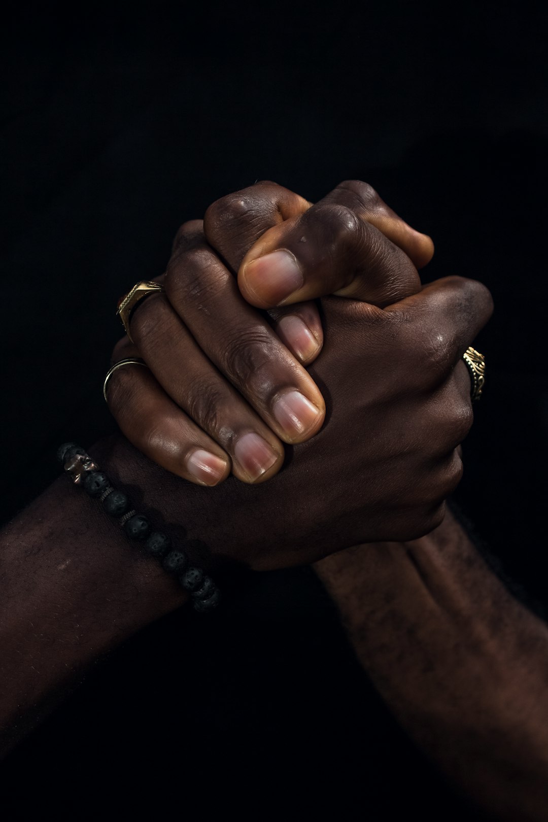 a close up of two people holding hands