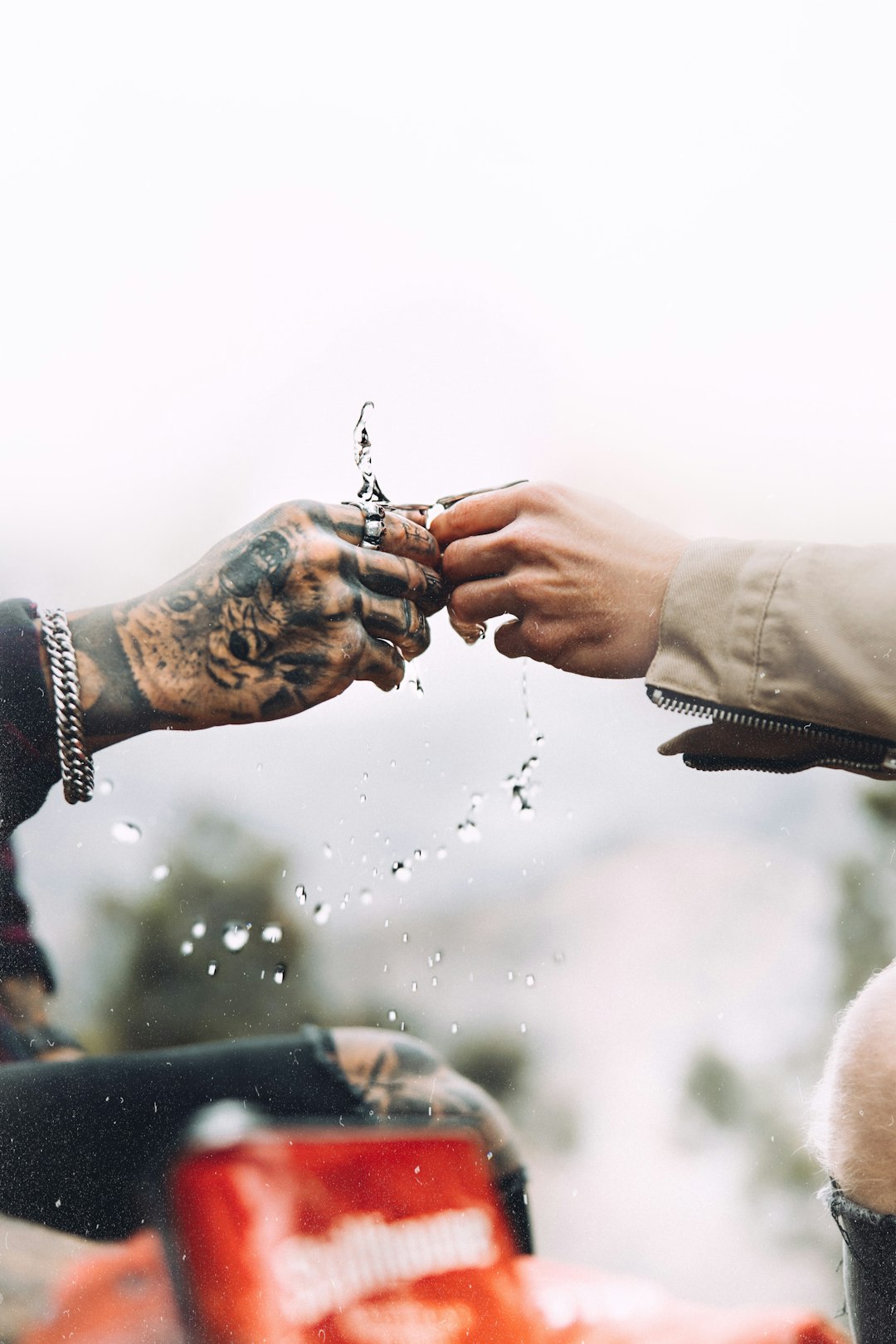 a man and a woman holding hands over a motorcycle