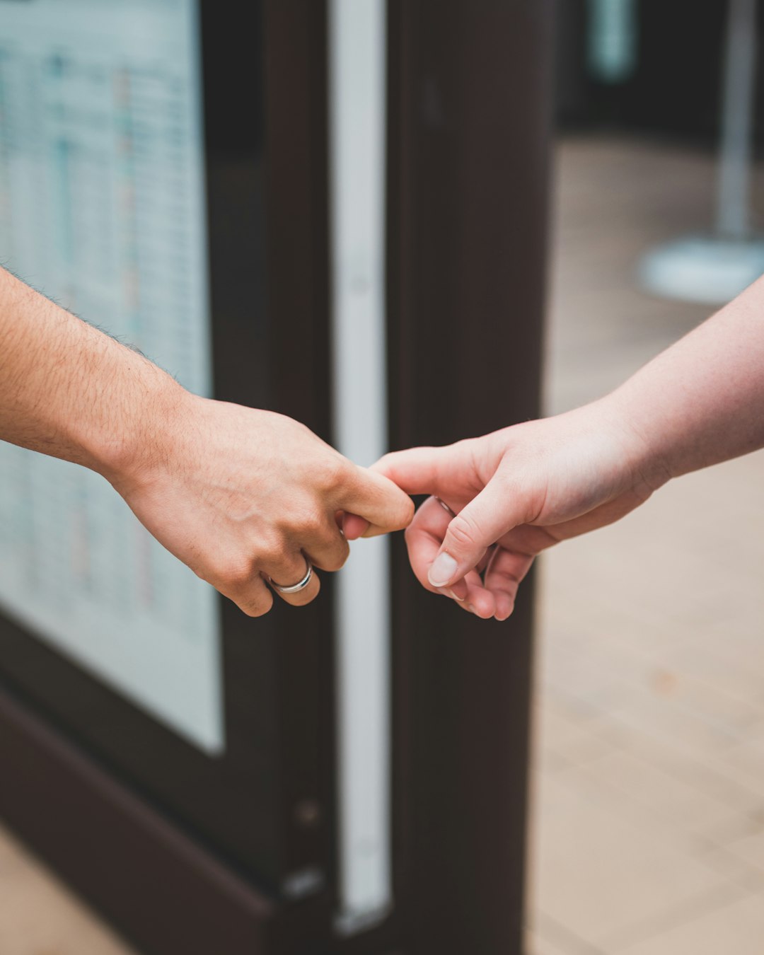 person holding hands of woman