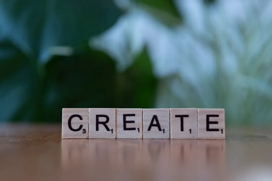 Wooden letter blocks spelling 'CREATE' against a blurred green background.
